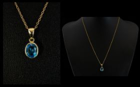 A Faceted Blue Topaz 9ct Gold Set Pendant The bale marked for 9ct gold, strung on yellow metal