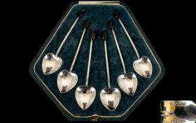 A Set Of Six Silver Coffee Spoons In fitted, velvet lined box with heart shaped bowls and coffee