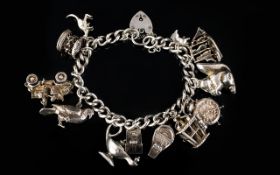 Solid Silver Curb Bracelet Loaded with 11 Nice Quality Silver Charms,
