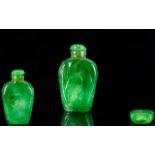Oriental Jadeite Snuff Bottle Of small proportion, with carved foliate scroll to front,