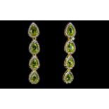 Peridot Long Drop Earrings, each earring comprising four pear cut peridots set in a vertical line in