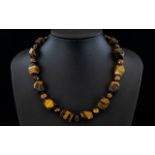 Tiger Eye Fancy Cut Bead Necklace, a strand of smoothly faceted cuboid tiger eye beads,