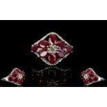 Ruby Flower Lozenge Shape Ring, eight oval cut rubies, of good, strong colour,