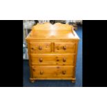A Pine Chest Of Drawers raised on bobbin feet,