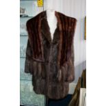 Attractive Mink Coat Dark Brown, three quarter length with revere collar and slit pockets.