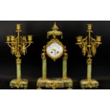 A French Green Onyx Clock Garniture comprising central portico clock, ormolu mounted,
