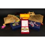 A Collection of Oriental Toys to include two boxed games and fans,