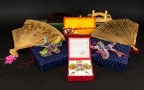 A Collection of Oriental Toys to include two boxed games and fans,