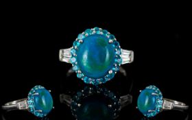 Opalina and Neon Apatite Halo Ring, a 3.75ct oval cabochon of the rare opalina, a natural mix of