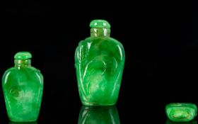 Oriental Jadeite Snuff Bottle Of small proportion, with carved foliate scroll to front, height 2