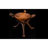 Carved African Tripod Bowl Collapsible tripod base, each carved in figural form,