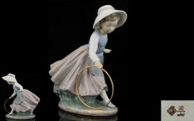 Nao by Lladro Porcelain Figure Young girl playing with hoop. 8 inches high.