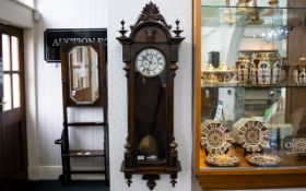 Vienna Wall Clock Walnut case with mask finial, white enamel dial and Roman numerals.