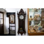 Vienna Wall Clock Walnut case with mask finial, white enamel dial and Roman numerals.