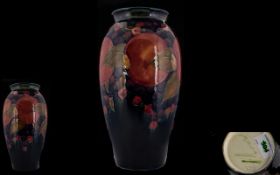 William Moorcroft Signed Early Pomegranate and Berries Pattern Tall Vase of pleasing form.