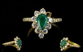 18ct Gold Emerald And Diamond Cluster Ring Pear shaped emerald surrounded by 10 round brilliant cut