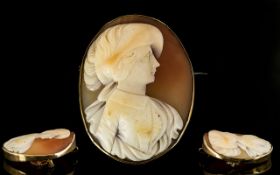 Early 20th Century Oval Shaped Shell Cameo Brooch with a 9ct gold mount and attached gold safety