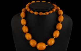 Antique Amber Coloured Hand Knotted Graduating Bead Necklace Comprising barrel form bead,