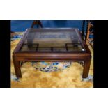 A Modern Oriental Style Coffee Table - low square table with insert glass top and decorative grid