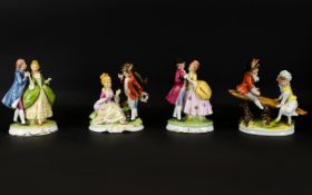 Sitzendorf Style Figures, each raised on oval bases,with gilt trim to include girl and boy on see-