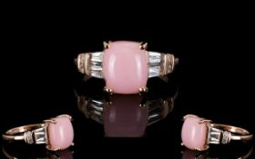 Pink Opal and White Topaz Ring, a 3ct elongated cushion cut cabochon of Peruvian pink opal,