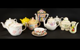 A Collection Of Novelty Decorative Tea Pots to include boot house tea pot with bears,