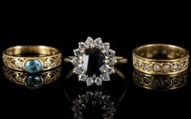 Three 9ct Gold Dress Rings Comprising blue topaz and diamond chip, full eternity and a cluster ring.
