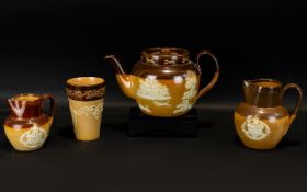 A Mixed Lot Of Doulton Lambeth Ceramics Comprising two teapots, three jugs and a mug.