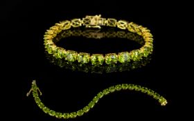 Peridot Tennis Bracelet, 31cts of oval cut peridots of rich colour and sparkle,