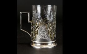 Russian Silver Tea Glass / Podstakannik Of typical form with cut glass inner and pierced silver