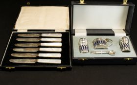 A Set Of Silver Butter Knives Complete with original fitted case, each with pearlescent handles,