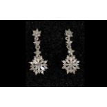 Diamond Pair of Drop Earrings, a starbur