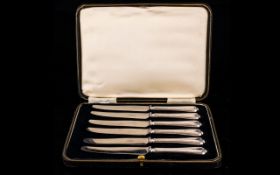 A Set Six Of Silver Butter Knives Each with lobed shell design handles, each marked R.