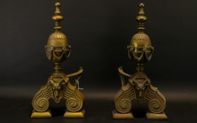A Pair Of Early 20th Century Brass Fire Dogs Each raised on stepped scroll body with applied rams