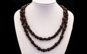 Antique Long Amber Coloured Beaded Necklace Comprising oval beads set between spherical and
