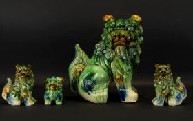 A Collection Of Four Oriental Dogs Of Foo/ Guardian Lions Modern ceramic figures in traditional