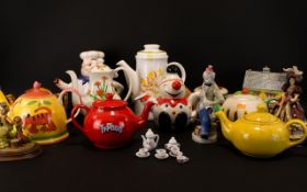 A Collection Of Novelty Decorative Tea Pots To Include, A Novelty Piano Shaped Tea Pot,