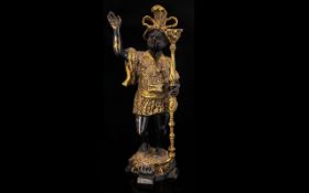 A Gilt Bronze Blackamore Figural Candle Holder Raised on quatrefoil base, height, 16 inches,