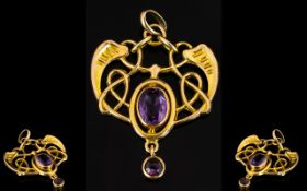 A 9ct Gold Art Nouveau Pendant Set with an oval faceted amethyst with amethyst drop of Celtic