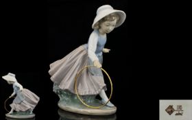 Nao by Lladro Porcelain Figure Young girl playing with hoop. 8 inches high. First quality and mint