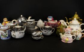 A Collection Of Novelty Decorative Tea Pots To Include,
