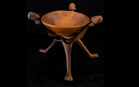 Carved African Tripod Bowl Collapsible tripod base, each carved in figural form, the central bowl of