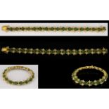 18ct Gold Emerald And Diamond Bracelet Comprising fifteen links,