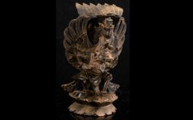Oriental Carved Wooden Figure Intricately carved god depicted riding on the back of a dragon.