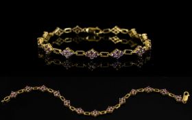 9ct Gold Gemset Bracelet Lozenge form links, each set with four faceted pale purple gemstones. Fully