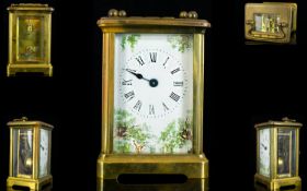 Brass Framed Carriage Clock Of Typical form, white enamel dial with transfer printed shrubbery