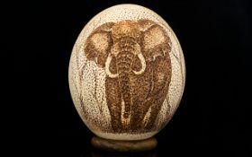 Large Ostrich Egg Scrimshaw depicting a large bull elephant - face on. 6.25" - 15.65 cm.