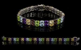 Red Garnet, Peridot, Amethyst, Sky Blue Topaz and Citrine Two Row Bracelet, 29cts of the gemstones,