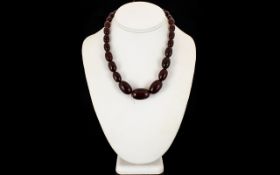 Cherry Amber Coloured Antique Bead Necklace Comprising 27 oval graduated beads with barrel screw