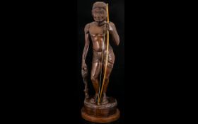 Carved Wood Figure In The Form Of A Huntsman Dark wood figure carved as an archer in loin cloth